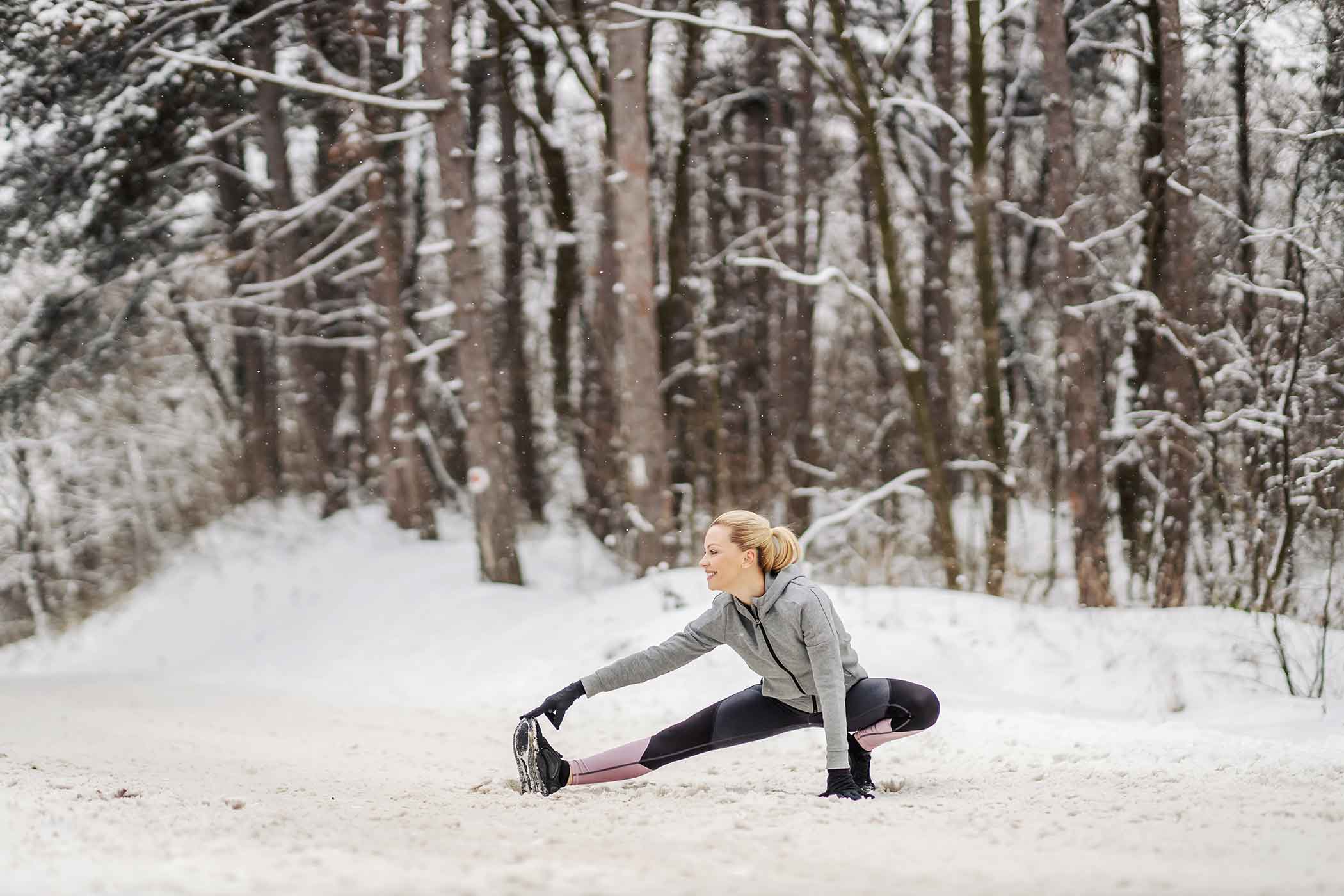 Girl stretching in snow